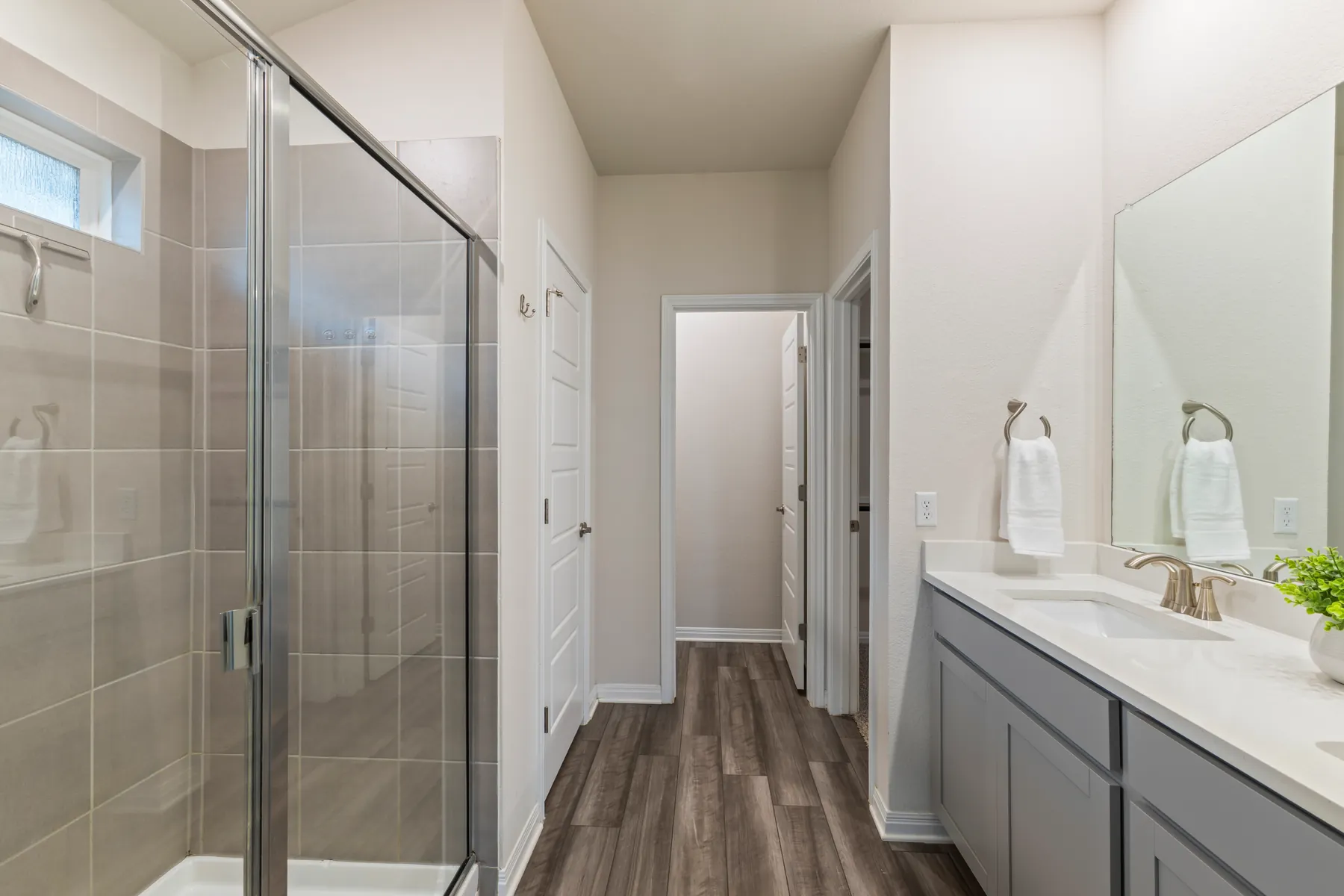 Primary bathroom with glass shower and double vanity